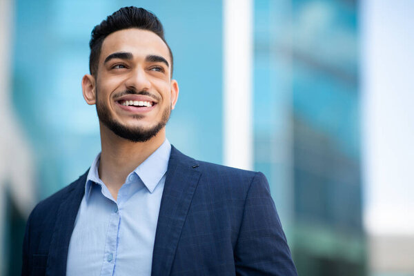 Wealthy arab man in suit looking at copy space