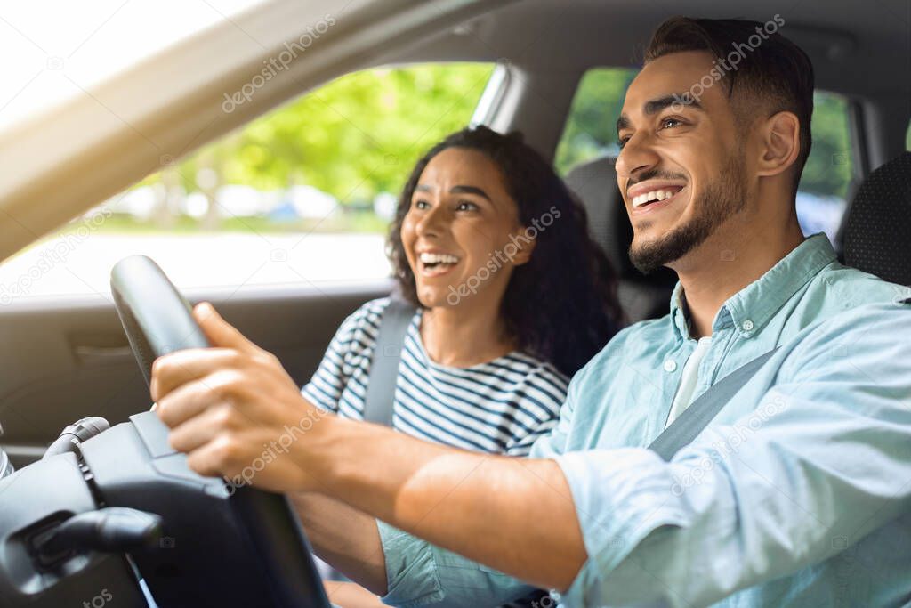 Emotional middle-eastern couple travelling by car together