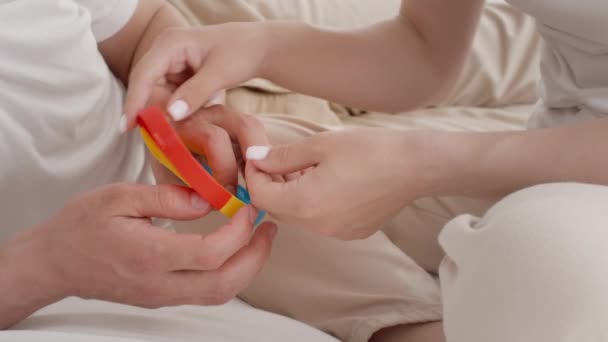 Взрослые мужчины и женщины играют с красочными поп-это игрушка дома — стоковое видео