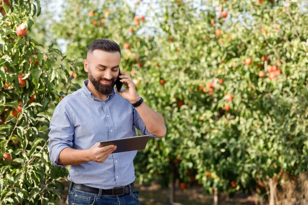 Negocio moderno, propietario de hombre trabaja en eco granja, nueva tecnología normal, móvil para el cultivo de frutas orgánicas — Foto de Stock