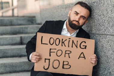 Olgun iş adamı, karantina yüzünden işini kaybetti. İş arıyor, elinde karton tutuyordu. İşsizlik büyümesi kavramı