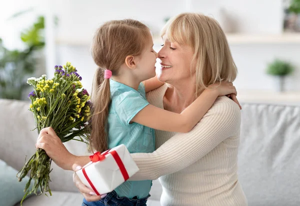 Little girl celebrating holiday, greeting her grandma — Stock Photo, Image