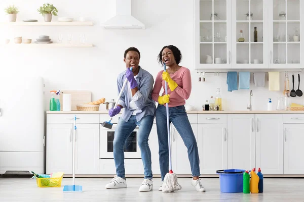 Joyful african american family having fun while cleaning kitchen together — Stock Photo, Image