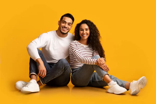 Porträtt av glada glada unga arabiska par poserar över gul bakgrund — Stockfoto