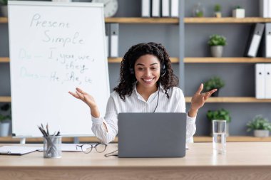 Afro-amerikalı mutlu bayan kara tahtada, işaret ediyor