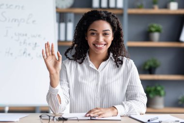 Siyah kadın kara tahtanın arka planında, iç mekanda.