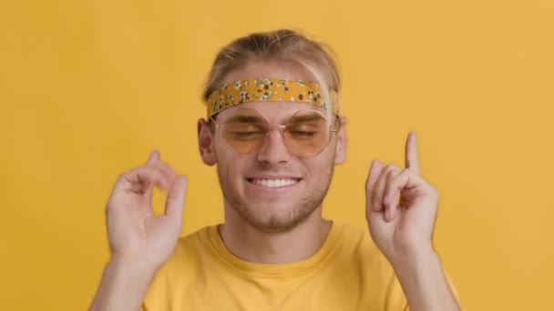 Portrait Of Cheerful Dancing Hippie Guy Wearing Headband And Colorful Sunglasses — Stock Video