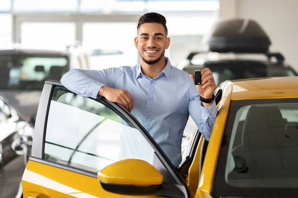 Bonito árabe homem cliente segurando chave de auto e sorrindo — Fotografia de Stock