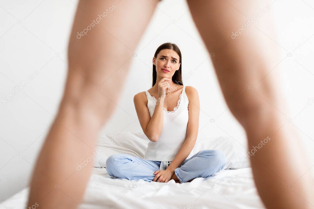 Disappointed Girlfriend Looking At Whats Between Boyfriends Legs Sitting Indoor