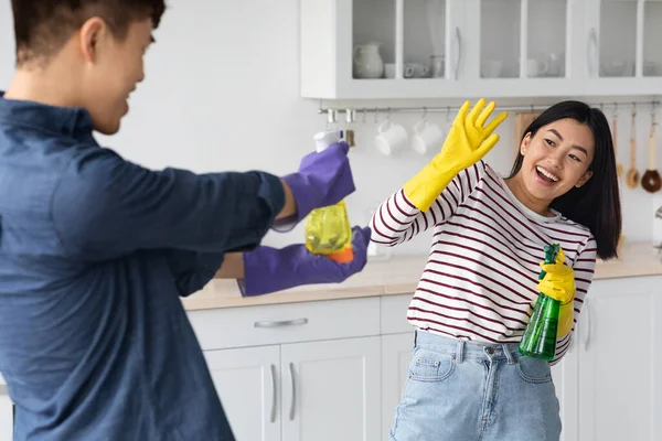 Brincalhão asiático amantes ter diversão enquanto limpeza casa juntos — Fotografia de Stock