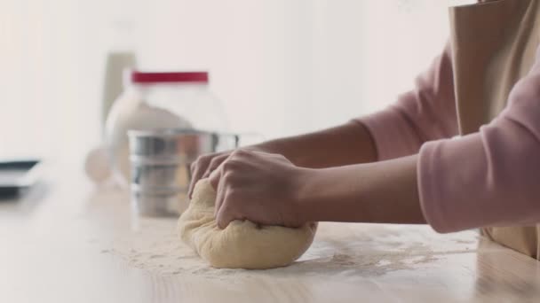 Making homemade bread. Close up of unrecognizable girl hands kneading raw dough, preparing bakery dessert at kitchen — Stock Video