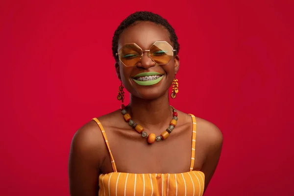 Mulher milenar afro-americana elegante vestindo óculos de sol agradáveis — Fotografia de Stock