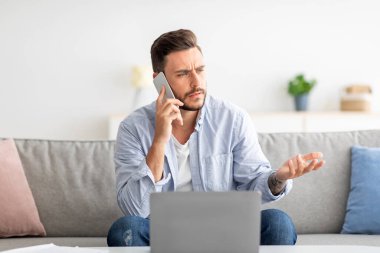 Hoş olmayan bir arama. Dizüstü bilgisayar üzerinde çalışırken internet bağlantısında sorun yaşamaktan endişelenen bir serbest yazar