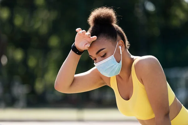 Woman wearing protective face mask while exercising