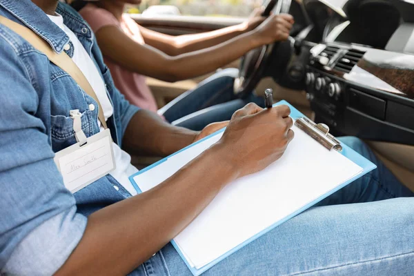 Instructor de conducción tomando notas durante el examen, concepto de escuela de conducción —  Fotos de Stock