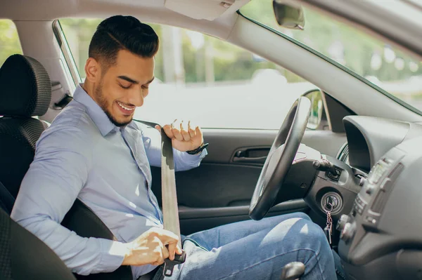 Positiv arabkille som spänner fast säkerhetsbälte, säkerhetskörningskoncept — Stockfoto