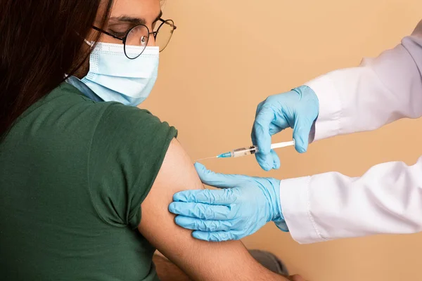 Verpleegster maakt intramuscualr injectie voor Arabier man in kliniek, close-up — Stockfoto