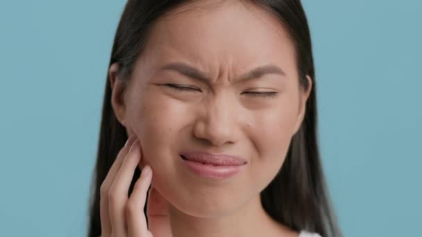 Unhappy Chinese Woman Suffering From Toothache Posing Over Blue Background — Stock Video