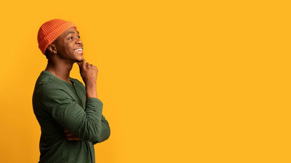 Interesting Offer. Cheerful Pensive Black Young Guy Touching Chin And Looking Aside — Stock Photo, Image