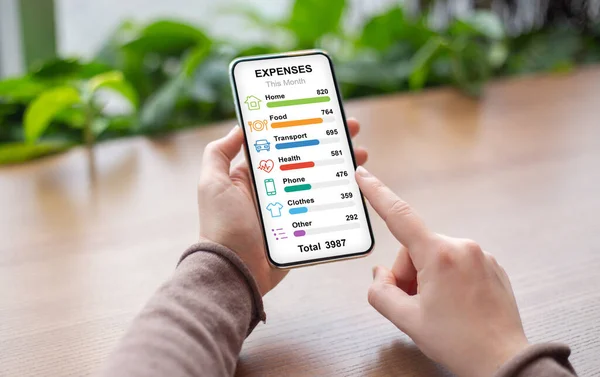 Woman checking her montly expenses while having coffee break — Stock Photo, Image