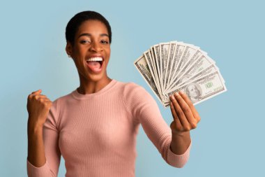 Büyük Kâr. Dolarlık Nakit ve Yükselen Yumruk Tutan Genç Zenci Kadın