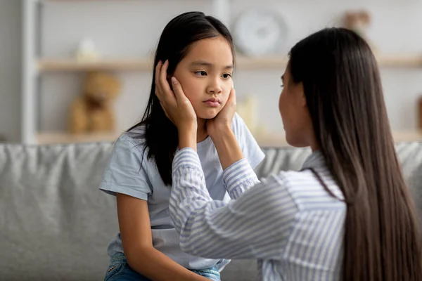 Concepto de problemas infantiles. Joven madre consolando a su triste hija ofendida después de pelearse en casa — Foto de Stock