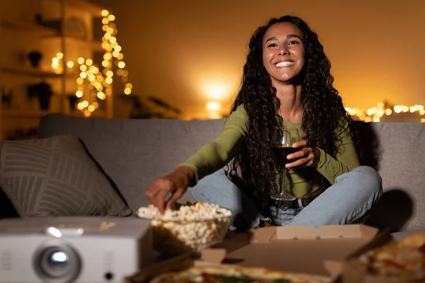 Happy Woman Watching Movie Using Home Cinema Projector Sitting Indoors — Stock Photo, Image