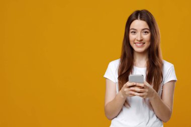 Bin yıllık heyecanlı sarışın kadın akıllı telefondan oyun oynuyor.