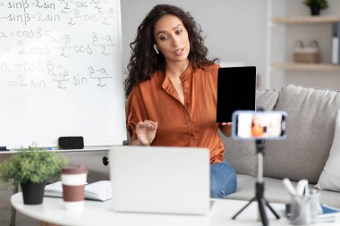 Bilgisayara tableti gösteren matematiği açıklayan kadın öğretmen