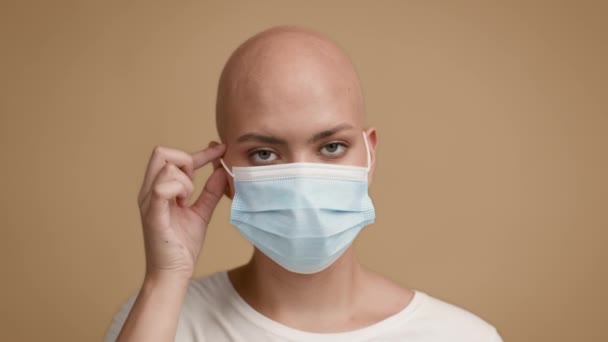 Happy Bald Lady Taking Off Face Mask On Beige Background — Stok Video