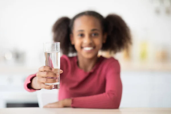 陽気なアフリカ系アメリカ人の女の子ティーンホールドガラスの水 — ストック写真