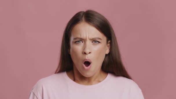 Shocked Woman Expressing Disgust Negative Emotion Shaking Head, Pink Background — Stockvideo