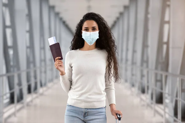 Viajes pandémicos. Mujer joven feliz en máscara médica protectora posando en el aeropuerto —  Fotos de Stock