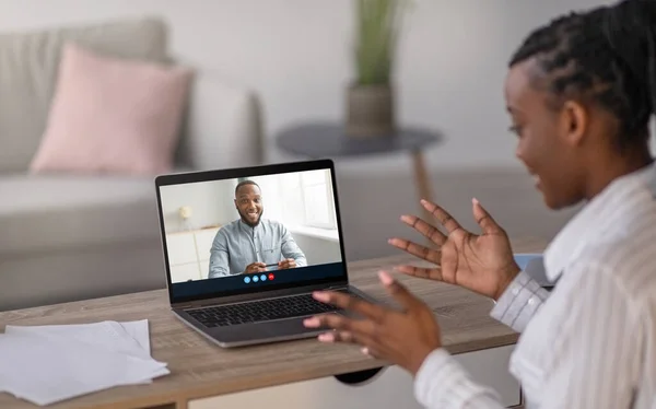 Millennial african american lady gestures, studies at home and watches video lesson, webinar — Stock Photo, Image