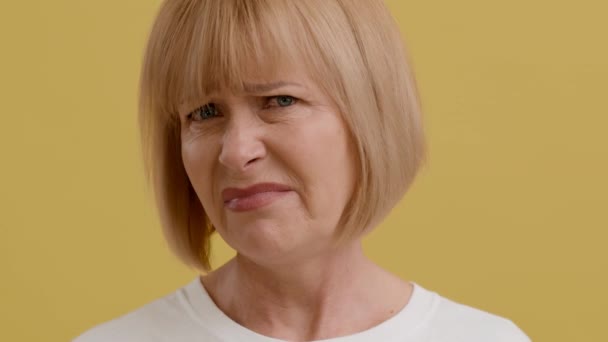 Closeup Portrait Of Disgusted Senior Woman Looking At Camera And Frowning Face — Stock Video