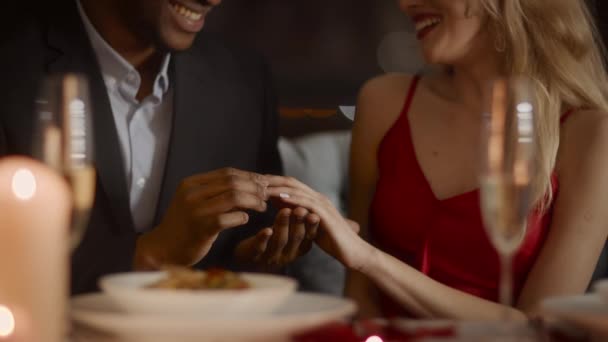 Black Man Proposing To Woman Putting On Ring In Restaurant — Stock Video