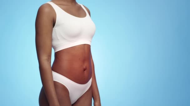 Digestive problems. Unrecognizable african american woman posing with red pulsating belly, suffering from stomach pain — Stock Video