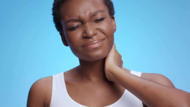 Jovem chateado afro-americano senhora massageando seu pescoço dolorido, sofrendo de inflamação do corpo, close-up retrato — Vídeo de Stock