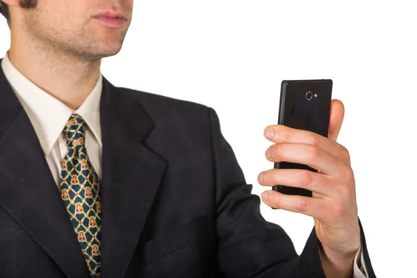 Mann in Anzug und Krawatte schaut auf sein schwarzes Smartphone — Stockfoto