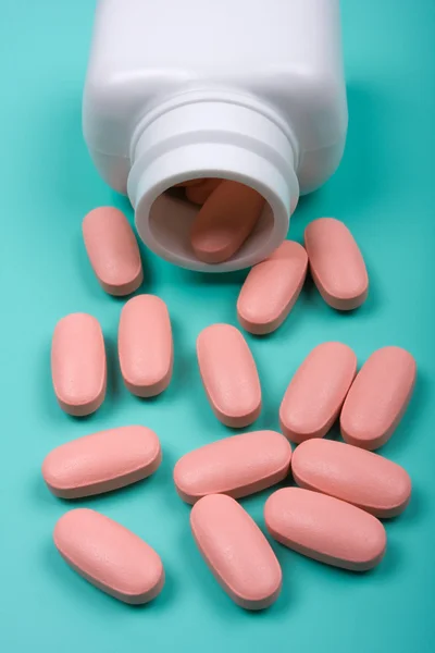 Pills scattered around the bottle — Stock Photo, Image