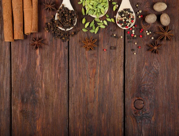 Variety of spices in wooden spoons — Stock Photo, Image