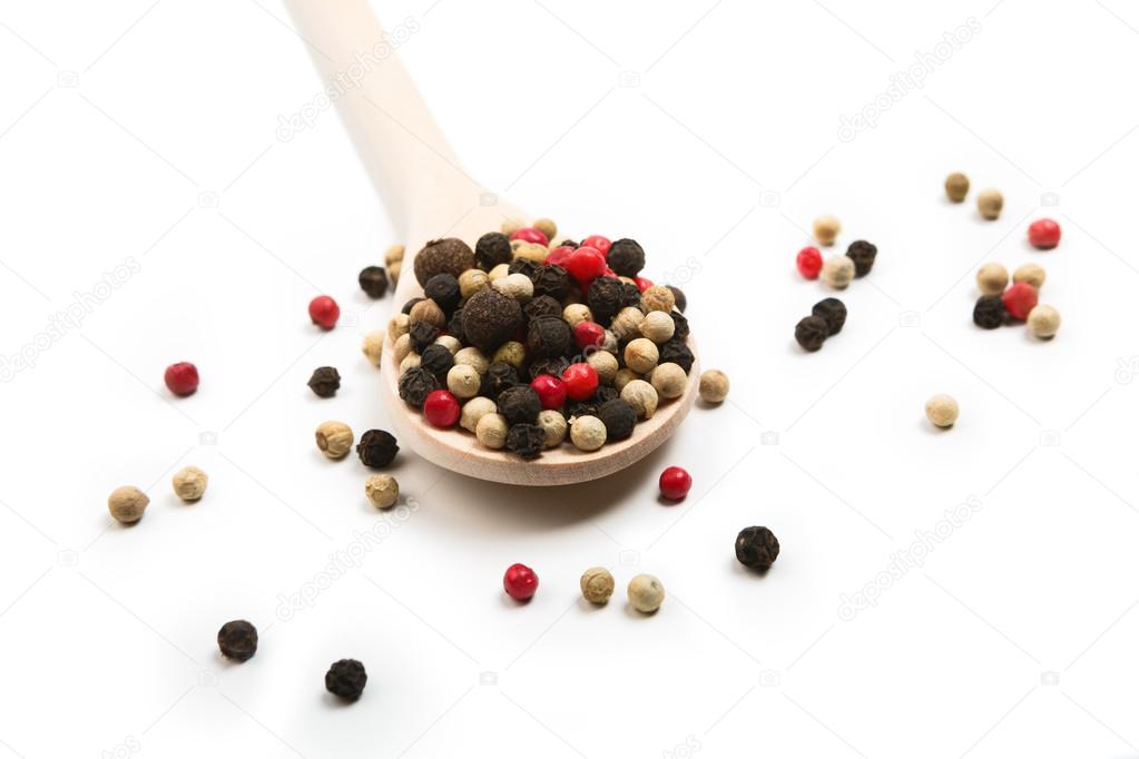 Mix of pepper seasoning in a wooden spoon