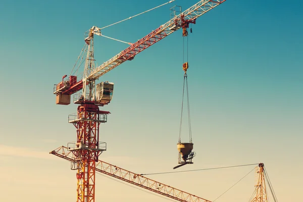 Menara crane mengangkat ember semen di daerah konstruksi — Stok Foto