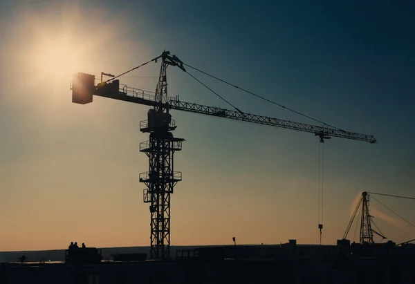 Silueta de la grúa torre en el área de construcción —  Fotos de Stock