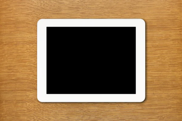 Белый планшетный компьютер с черным экраном на столе — стоковое фото