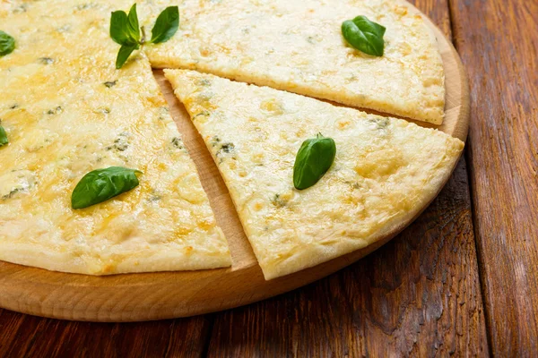 Delicious four cheese pizza with basil leaves — Stock Photo, Image