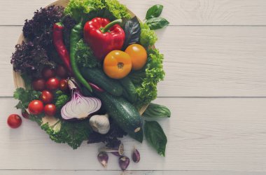 Healthy cooking ingredients on board, vegetable background on white wood with copy space. Vintage filter