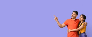 Neşeli bir çift yan yana durur, biri işaret ederken diğeri gülümser. Mutlu ve meşgul görünüyorlar. Kapalı bir ortamda birbirlerine eşlik ederek eğleniyorlar..