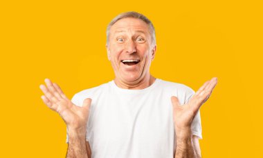 Heyecan ve mutluluğu elleri havada gösteren bir adam. Onun yüzünde büyük bir gülümseme var. Arka plan parlak sarı, manzaranın hareketli atmosferine ekleniyor..