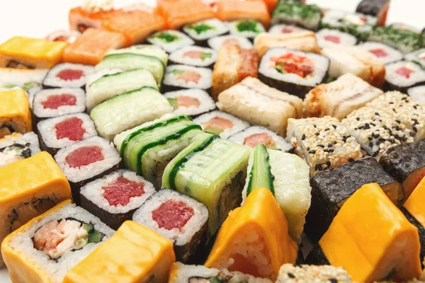 Sushi tabağı beyaz arka planda yakın plan. Japon yemek restoranı teslimatı - maki, peynir ve California ruloları daire içine alındı